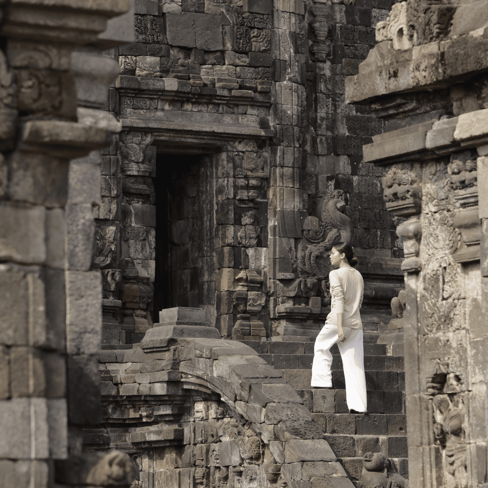 woman walking upstairs of one of the biggest temple in Indonesia